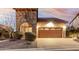 Beautiful home exterior featuring a stone tower and desert landscaping at 8542 E Indigo St, Mesa, AZ 85207