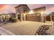 Home exterior with stone accents, desert landscaping, and driveway pavers at 8542 E Indigo St, Mesa, AZ 85207