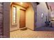 Home entryway featuring a dark wooden door and a brick-paved front patio at 8542 E Indigo St, Mesa, AZ 85207