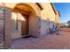 Inviting front porch featuring a stylish entrance, brick pavers, and comfortable seating at 8542 E Indigo St, Mesa, AZ 85207