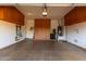 Spacious garage with epoxy floor, storage cabinets and organization, and utility connections at 8542 E Indigo St, Mesa, AZ 85207