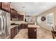 Modern kitchen featuring stainless steel appliances, granite counters, and open layout to dining area at 8542 E Indigo St, Mesa, AZ 85207