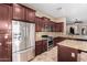 Bright kitchen showcases stainless steel appliances, granite counters, and plentiful dark wood cabinetry at 8542 E Indigo St, Mesa, AZ 85207