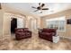 Bright living room with tile flooring, arched doorways, and comfortable leather sofas at 8542 E Indigo St, Mesa, AZ 85207