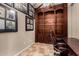Home office with built-in shelving and desk, and tile flooring, surrounded by framed art at 8542 E Indigo St, Mesa, AZ 85207