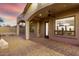 Covered patio with brick pavers, multiple archways and views of the backyard with a firepit at 8542 E Indigo St, Mesa, AZ 85207