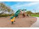 Community playground with slides, climbing structures, and a spring rider for recreation at 8542 E Indigo St, Mesa, AZ 85207
