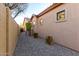This house features a low-maintenance side yard with gravel and desert landscaping for easy upkeep at 8542 E Indigo St, Mesa, AZ 85207