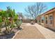Serene backyard oasis featuring desert landscaping, a dining area on a brick patio, and a tranquil outdoor setting at 8877 E Riviera Dr, Scottsdale, AZ 85260