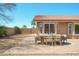 Cozy backyard with a paved patio, desert landscaping, and a dining set, creating an inviting outdoor living space at 8877 E Riviera Dr, Scottsdale, AZ 85260