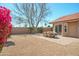 Charming backyard with colorful bougainvillea, a paved patio, and a dining set, perfect for outdoor entertaining at 8877 E Riviera Dr, Scottsdale, AZ 85260