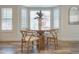 Bright dining area featuring a round glass table and wood chairs in front of shuttered windows at 8877 E Riviera Dr, Scottsdale, AZ 85260