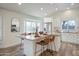 Bright kitchen with stainless steel appliances, white cabinets, and an island with seating at 8877 E Riviera Dr, Scottsdale, AZ 85260