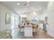 Modern kitchen with stainless steel appliances, white cabinetry, and a large center island at 8877 E Riviera Dr, Scottsdale, AZ 85260