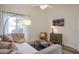 Comfortable living room with a sofa, TV, and neutral decor at 8877 E Riviera Dr, Scottsdale, AZ 85260