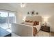 Bright main bedroom featuring a sliding glass door, ceiling fan, and elegant decor at 8877 E Riviera Dr, Scottsdale, AZ 85260