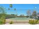 Community tennis court surrounded by lush greenery, providing a recreational space for active residents and sports enthusiasts at 8877 E Riviera Dr, Scottsdale, AZ 85260