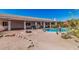 Entertainer's backyard featuring a pool, fire pit, covered patio, and desert landscaping at 9401 N 122Nd Pl, Scottsdale, AZ 85259