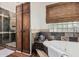 Elegant bathroom with modern tub, natural wood accents, and walk-in shower at 9401 N 122Nd Pl, Scottsdale, AZ 85259