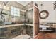Luxurious bathroom with glass shower, stone accents, and wooden cabinets at 9401 N 122Nd Pl, Scottsdale, AZ 85259