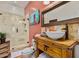 Bathroom featuring modern vessel sink, walk-in shower, and vibrant decor at 9401 N 122Nd Pl, Scottsdale, AZ 85259