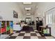 Versatile bonus room with checkered flooring, comfortable seating, and kitchenette at 9401 N 122Nd Pl, Scottsdale, AZ 85259