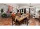 Open floor plan with dining room and living room featuring terra cotta flooring at 9401 N 122Nd Pl, Scottsdale, AZ 85259