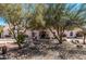 Well maintained home with mature trees and rock landscaping at 9401 N 122Nd Pl, Scottsdale, AZ 85259
