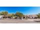 Attractive home with desert landscaping and attached three-car garage with tile roof and white stucco exterior at 9401 N 122Nd Pl, Scottsdale, AZ 85259