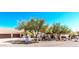 Spacious home with attached three-car garage surrounded by desert landscaping and native trees at 9401 N 122Nd Pl, Scottsdale, AZ 85259