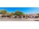Charming white home with a tile roof, lush landscaping, and a circular driveway, perfect for curb appeal at 9401 N 122Nd Pl, Scottsdale, AZ 85259