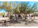 Charming exterior with desert landscaping featuring rock, gravel, and drought resistant plants and trees at 9401 N 122Nd Pl, Scottsdale, AZ 85259