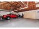Large garage with vehicle, overhead lighting, and ample storage for the homeowner at 9401 N 122Nd Pl, Scottsdale, AZ 85259