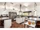 Bright kitchen with stainless steel appliances, central island, and terra cotta tile floors at 9401 N 122Nd Pl, Scottsdale, AZ 85259