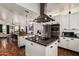 Open-concept kitchen with stainless appliances, kitchen island, and views into the dining and living areas at 9401 N 122Nd Pl, Scottsdale, AZ 85259