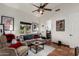 Open living room with comfortable seating, ceiling fan and a glimpse into the bathroom at 9401 N 122Nd Pl, Scottsdale, AZ 85259