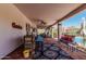Outdoor patio featuring a bar, comfortable seating, and views of the pool and lush greenery, great for relaxation at 9401 N 122Nd Pl, Scottsdale, AZ 85259