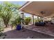 Spacious covered patio with tile flooring and view of the landscaped backyard at 9401 N 122Nd Pl, Scottsdale, AZ 85259