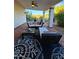 Inviting covered patio with comfortable seating, ceiling fan and desert landscape views at 9401 N 122Nd Pl, Scottsdale, AZ 85259
