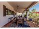 Expansive covered patio with a large dining table, seating area and mountain views at 9401 N 122Nd Pl, Scottsdale, AZ 85259