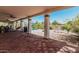 Expansive covered patio with tile flooring, outdoor kitchen, and backyard views at 9401 N 122Nd Pl, Scottsdale, AZ 85259