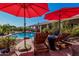 Relaxing poolside scene with lounge chairs, umbrellas, and a refreshing pool perfect for outdoor enjoyment at 9401 N 122Nd Pl, Scottsdale, AZ 85259