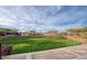 Community amphitheater features a grassy seating area and stone accents at 10043 W Foothill Dr, Peoria, AZ 85383