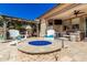 Inviting back patio featuring a cozy fire pit, comfortable seating, and stylish outdoor decor at 10043 W Foothill Dr, Peoria, AZ 85383