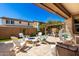 Beautiful back patio with a fire pit, outdoor seating, and a pergola for shade and entertaining at 10043 W Foothill Dr, Peoria, AZ 85383