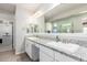 Bright bathroom with a dual sink vanity, granite counters and walk-in shower at 10043 W Foothill Dr, Peoria, AZ 85383