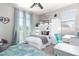 Stylish bedroom with a built-in bunk bed, study area, and light blue accents at 10043 W Foothill Dr, Peoria, AZ 85383