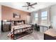 Bedroom with a warm color scheme, a decorative painting, and a well-lit study area at 10043 W Foothill Dr, Peoria, AZ 85383