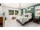 Comfortable bedroom with modern chandelier, tile floors, and a sunlit window at 10043 W Foothill Dr, Peoria, AZ 85383