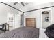 Bedroom with attached bathroom and walk-in closet, featuring a gray and white plaid bedspread at 10043 W Foothill Dr, Peoria, AZ 85383